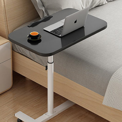 Adjustable overbed table with black tabletop, white legs, and caster wheels