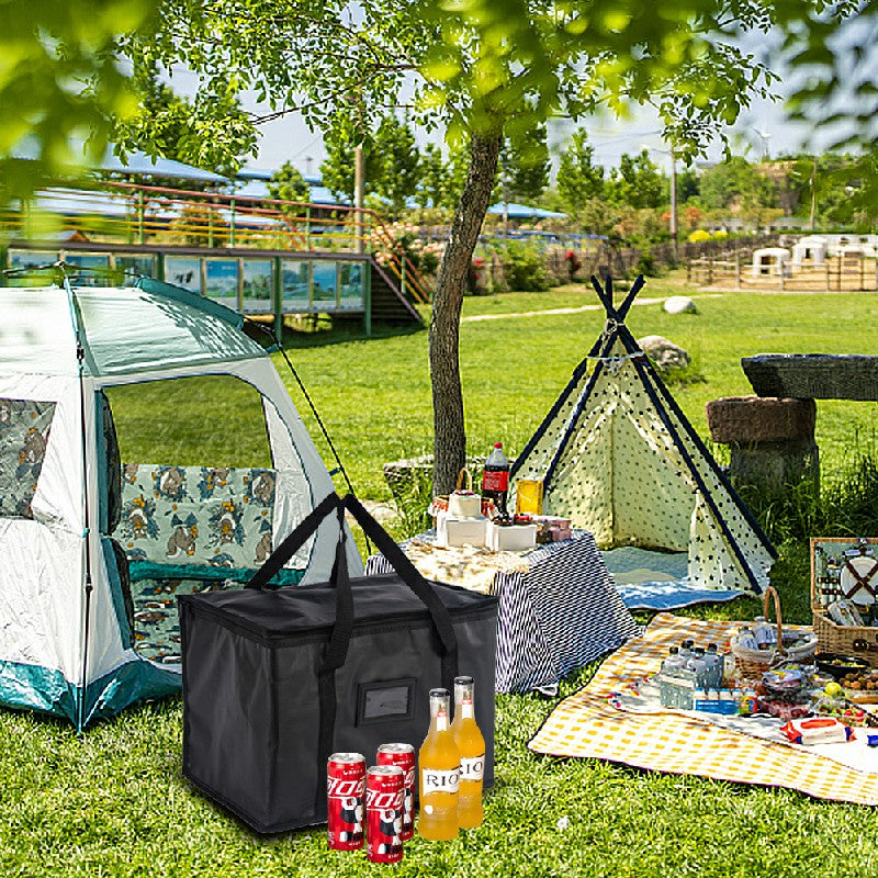Black insulated cooler bag with bottles visible inside on an outdoor table