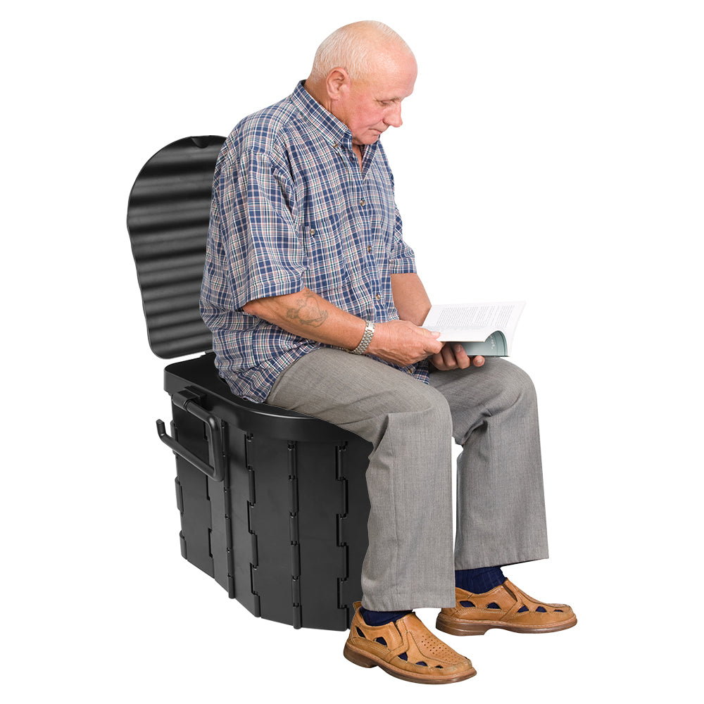 Folding portable toilet with open lid, black seat and waste bucket used by person