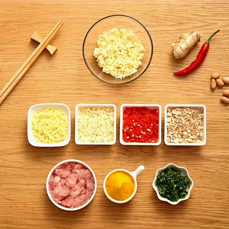 Manual food chopper with clear bowl and lid, shown with diced ingredient trays