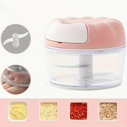 Manual food chopper with translucent bowl and light blue/pink lid, showing internal blade
