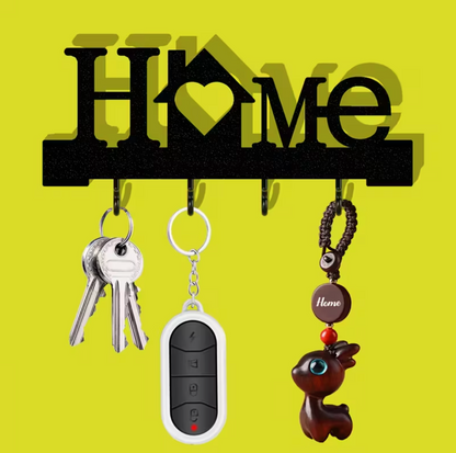 Black wall-mounted keychain holder with heart design and four hooks, keys and charm shown