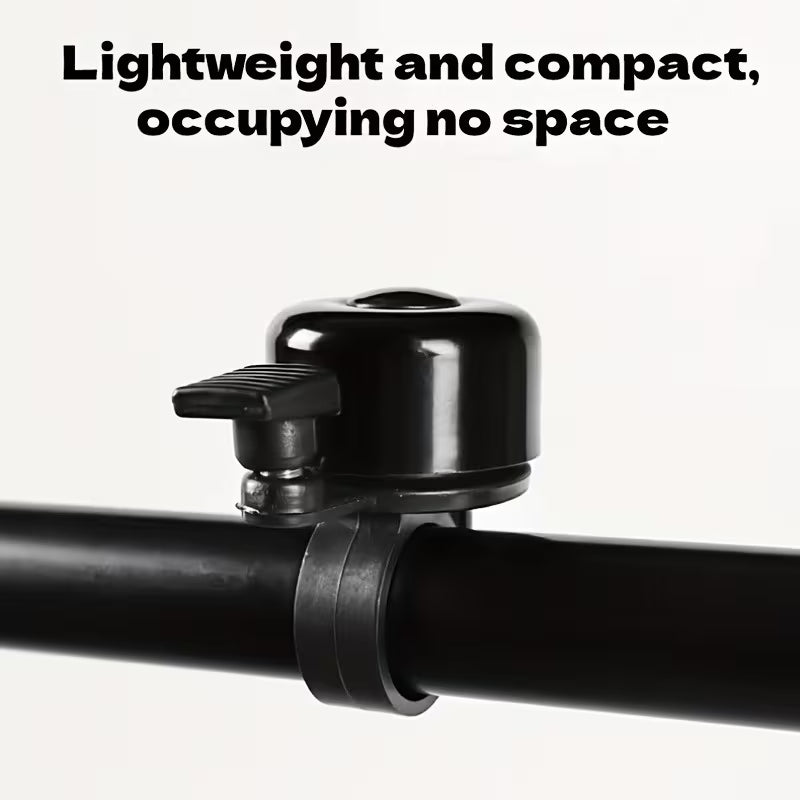 Compact black bicycle handlebar bell with clamp bracket on handlebar