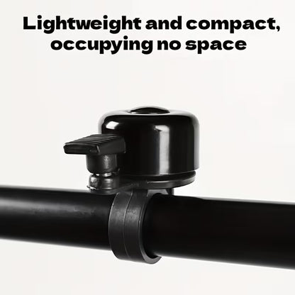 Compact black bicycle handlebar bell with clamp bracket on handlebar