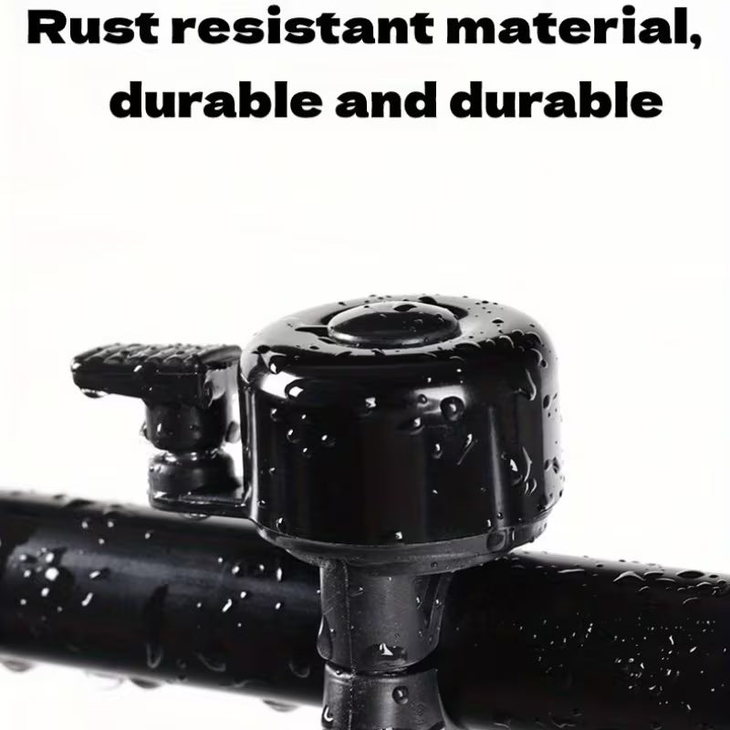 Black bicycle handlebar bell with mounting bracket, glossy top with water droplets
