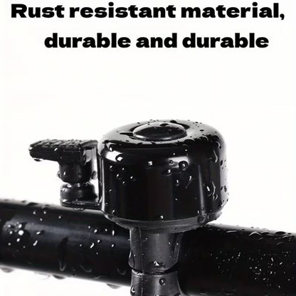 Black bicycle handlebar bell with mounting bracket, glossy top with water droplets