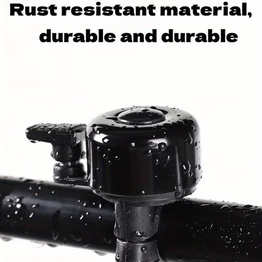 Black bicycle handlebar bell with mounting bracket, glossy top with water droplets