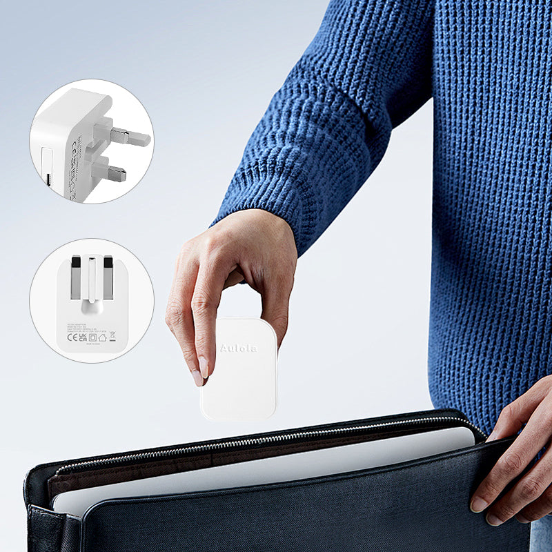 White foldable USB-C mains adapter being placed near a carry case for travel
