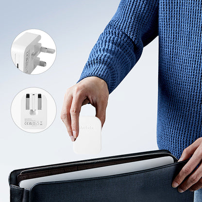 White foldable USB-C mains adapter being placed near a carry case for travel
