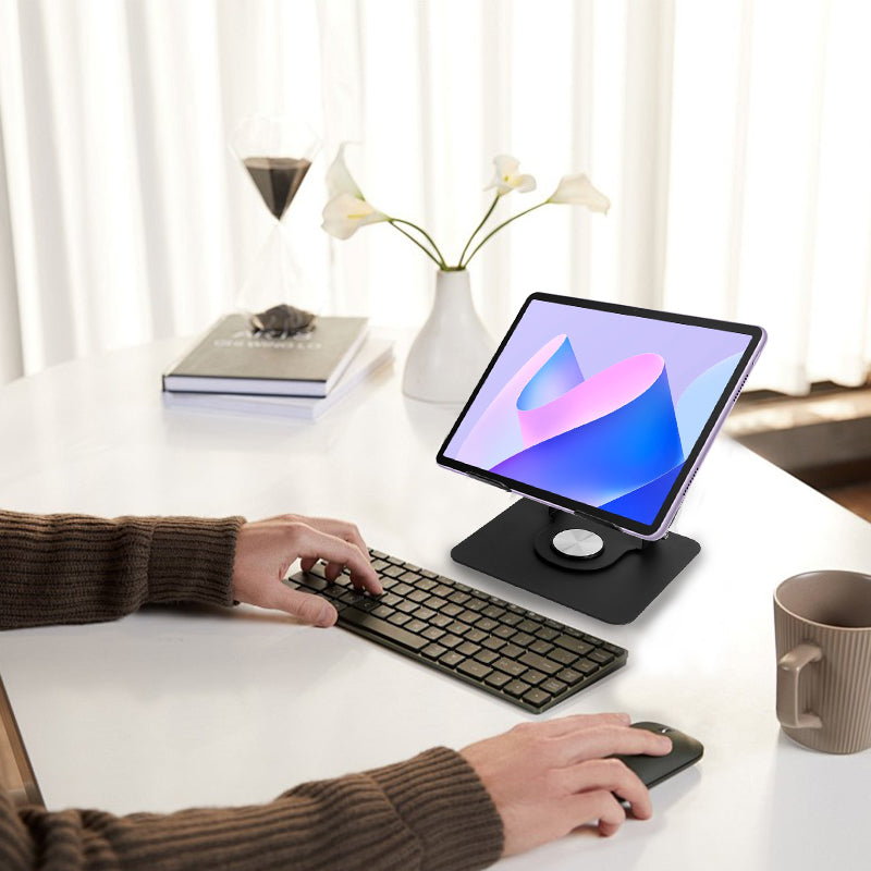 Black tablet stand on desk with cradle holding tablet and round base knob