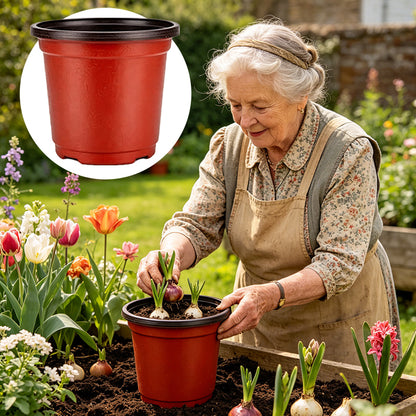Red plastic flower pot with onion seedlings in potting soil outdoors