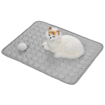 Grey self-cooling pet mat with raised honeycomb texture, cat resting on top.