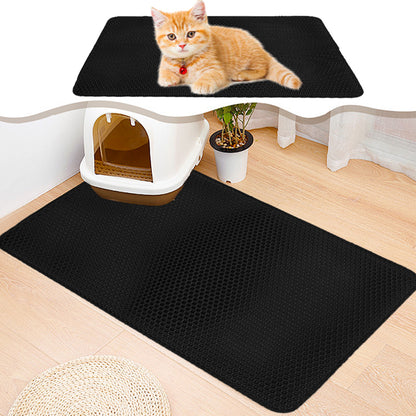 Black cat litter mat under a cat, rectangular raised texture for paw cleaning