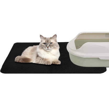 Black cat litter mat with raised texture, cat lying on the surface