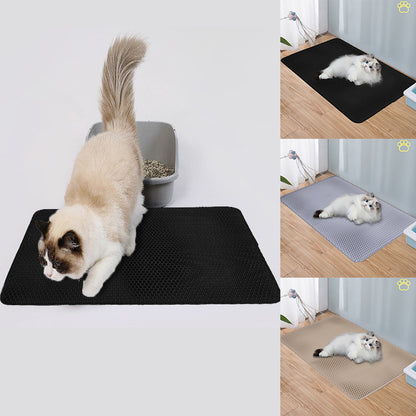Black cat litter mat with raised texture, pet resting on the surface