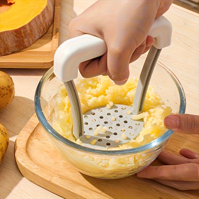 Handheld manual grater with white handle, grating plate over bowl of shredded potato