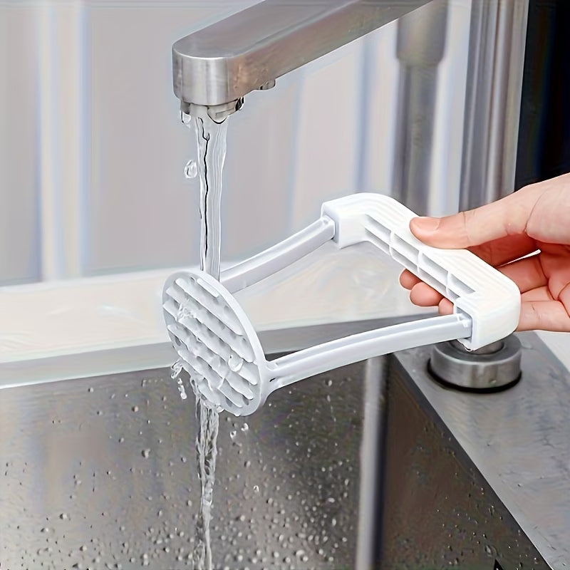 Manual hand grater attachment squeezing over sink, white handle and metal chute