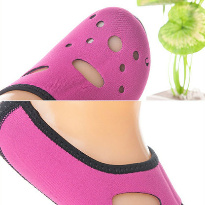 Rose red water sock with black collar and oval ventilation holes, close-up on ankle