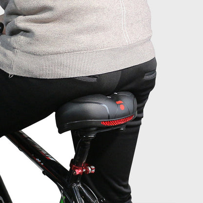 Black bike saddle with gel padding and red trim near rear mounting hardware