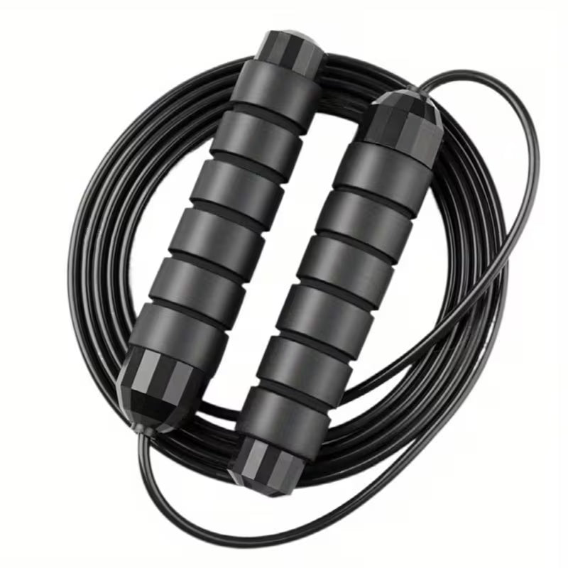 Coiled jump rope with two black padded handles and smooth bearings