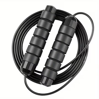 Coiled jump rope with two black padded handles and smooth bearings