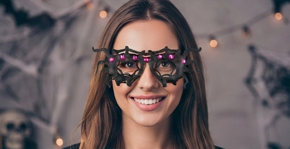 Black spider web costume glasses with bright pink gem eyes on the frame