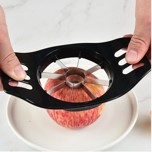Black manual apple corer slicer pressing an apple onto the stainless blade wheel
