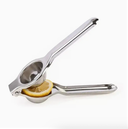 Stainless steel citrus juicer with cone reamer and lever handles, cut lemon inside