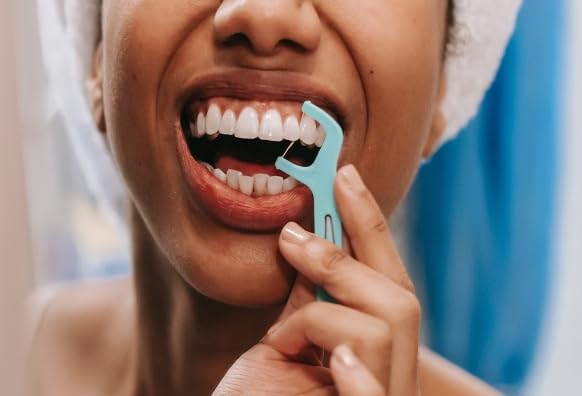 Mint dental floss pick used to clean between teeth