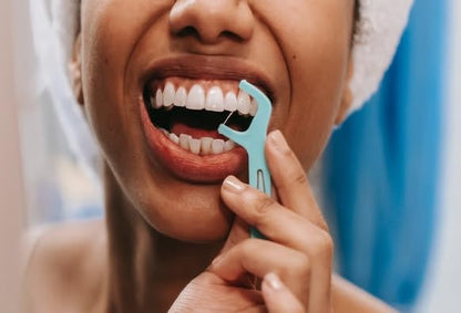 Mint dental floss pick used to clean between teeth