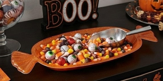 Orange fish-shaped candy serving tray filled with assorted Halloween candies