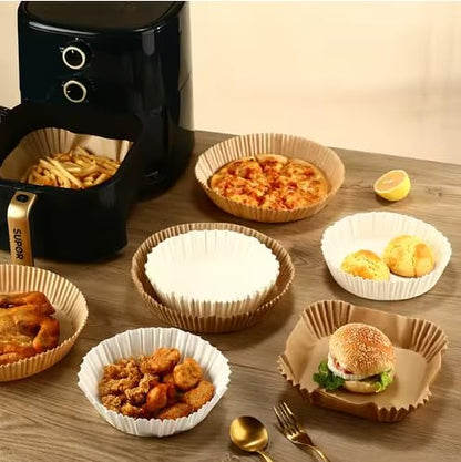 Round paper air fryer liners holding cooked foods in a kitchen setting
