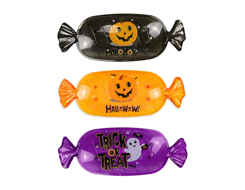 Black fish-shaped Halloween candy serving tray with jack-o-lantern face and Halloween text